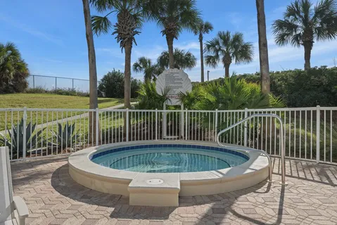 a view of a roof deck with a small swimming pool and a chair