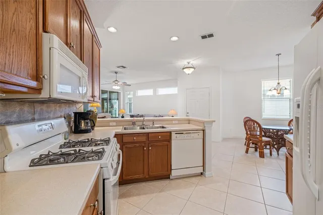 a kitchen with a sink and chairs