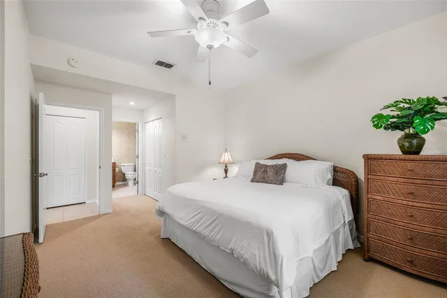 a bedroom with a bed and a potted plant