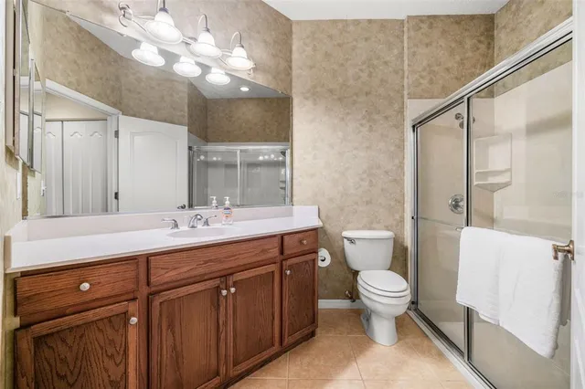 a bathroom with a double vanity sink and a toilet