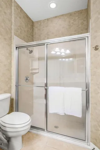 a bathroom with a glass shower door