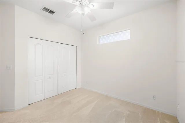 an empty room with a fan