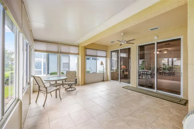 a view of swimming pool with table and chairs in floor