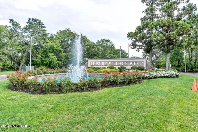 a view of a house with a big yard and large trees