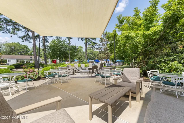 a view of a patio with a table and chairs and couches