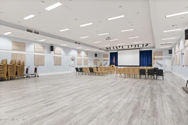 a view of a room with lots of furniture and a wooden floors