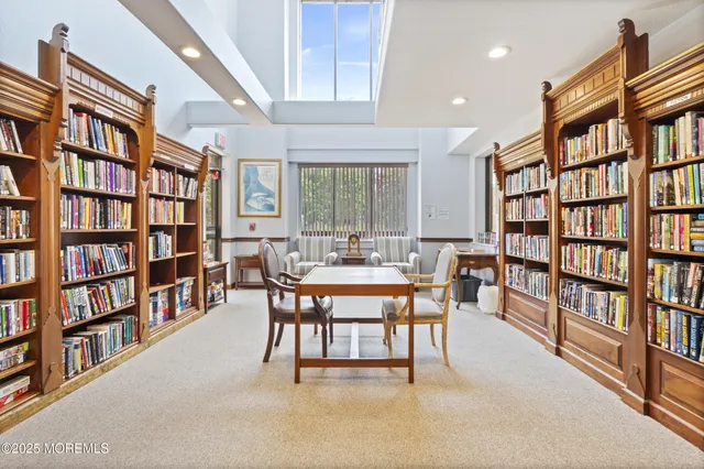 a dining room with furniture and a book shelf