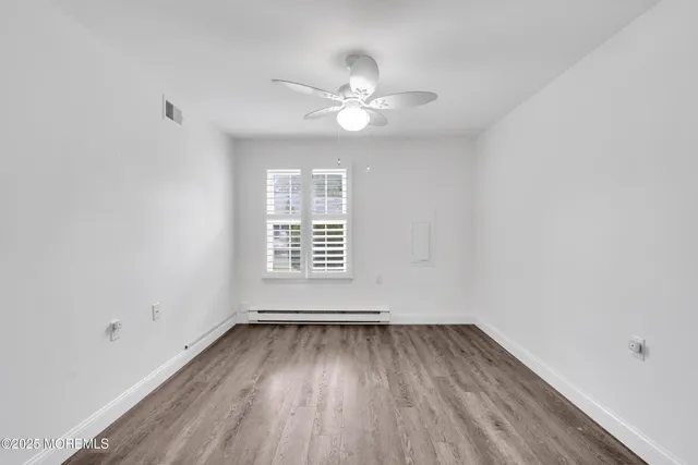 wooden floor in an empty room with a window