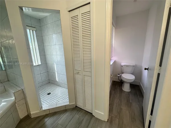 a bathroom with a double vanity sink and mirror