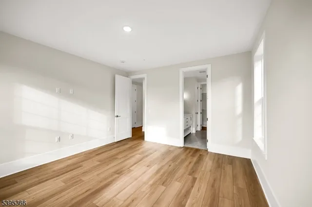 a view of an empty room and wooden floor