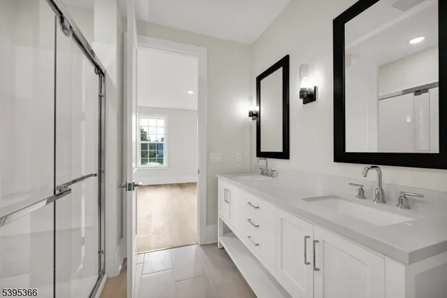 a bathroom with a double vanity sink and mirror