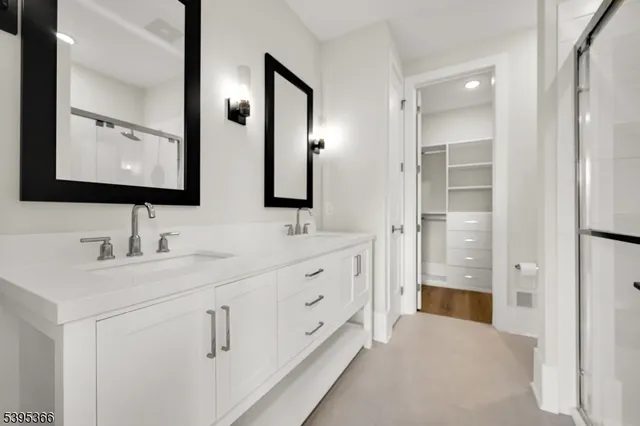 a bathroom with double sink and three mirror