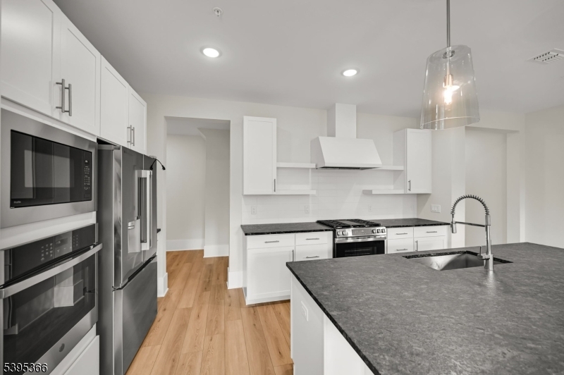 127 Myrtle Road Warren, NJ 07059 - Photo 5 of 27 a kitchen with stainless steel appliances granite countertop a stove a sink and a microwave