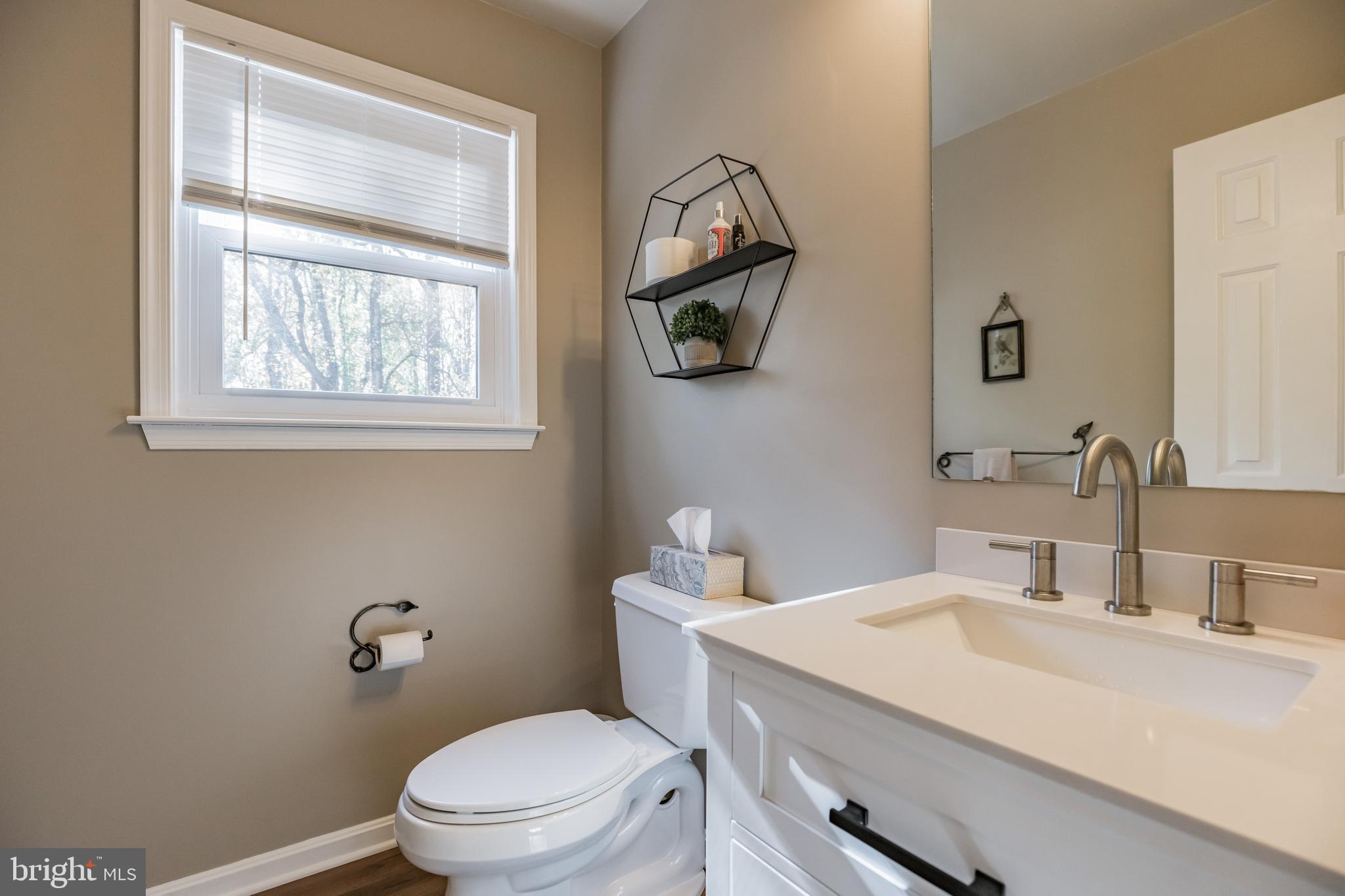 920 Carson Road Huntingtown, MD 20639 - Photo 16 of 32 a bathroom with a sink a toilet and a mirror