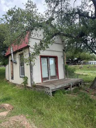 a view of a house with a yard and sitting area