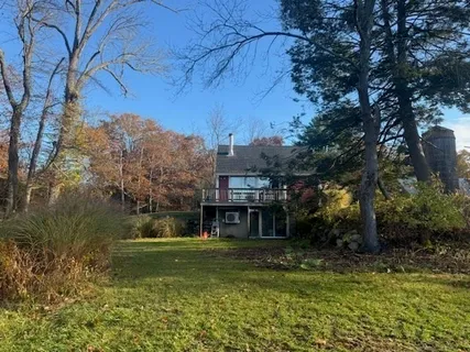 a front view of a house with a yard table and chairs