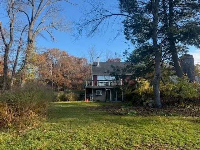 a front view of a house with a yard table and chairs