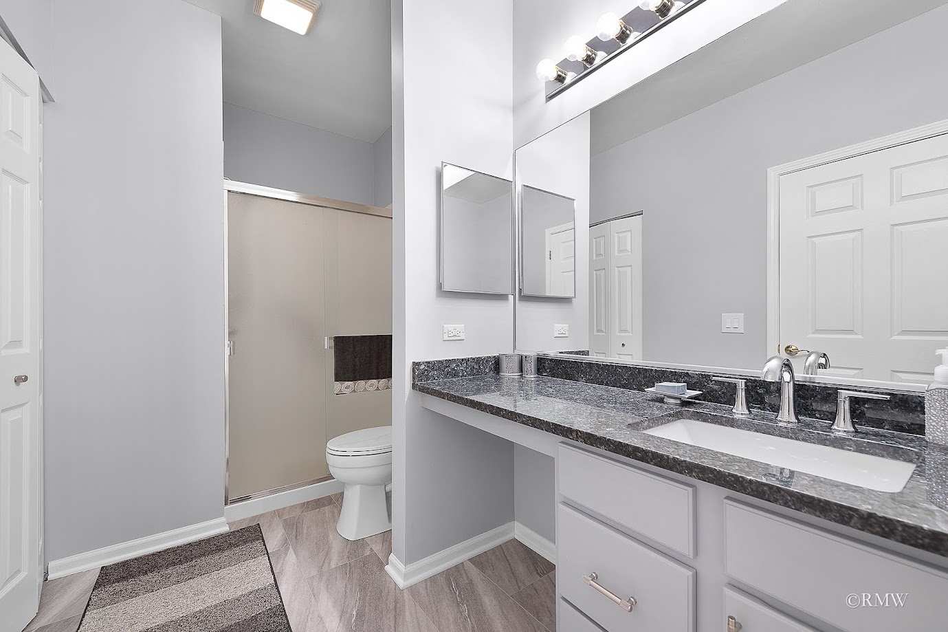 101 Bay Drive Itasca, IL 60143 - Photo 21 of 29 a bathroom with a granite countertop sink a toilet and a mirror
