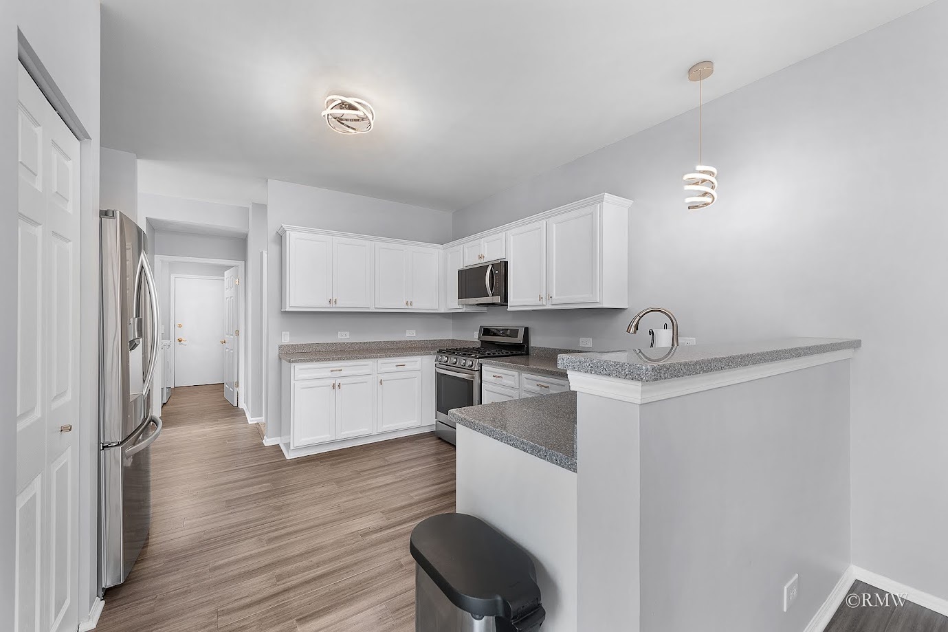 101 Bay Drive Itasca, IL 60143 - Photo 9 of 29 a kitchen with a sink cabinets and wooden floor