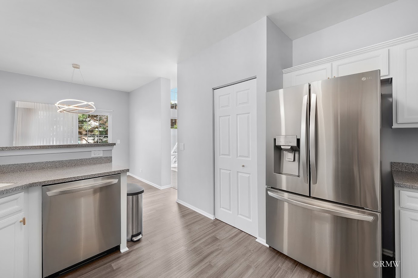 101 Bay Drive Itasca, IL 60143 - Photo 10 of 29 a kitchen with a refrigerator stainless steel appliances wooden floor and cabinets