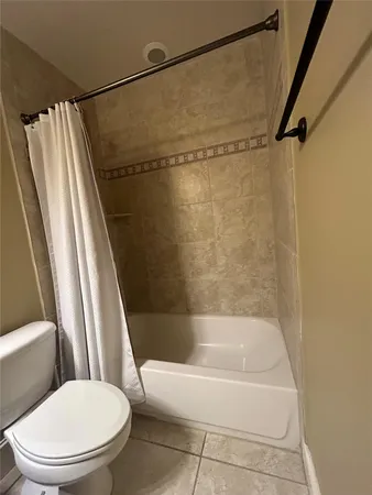 a bathroom with a shower and a toilet