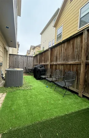 a view of backyard with wooden fence and a wooden fence
