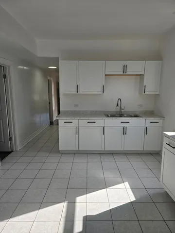 a kitchen with a sink a stove and cabinets