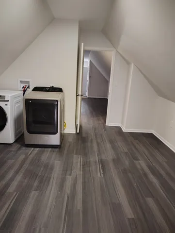 a view of a livingroom with wooden floor and a fireplace
