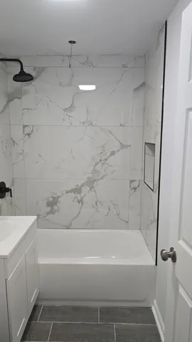 a bathroom with a bathtub and a shower