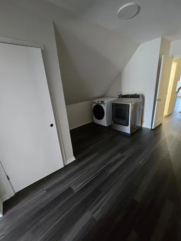 a utility room with wooden floor