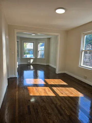 a room with pool table and windows