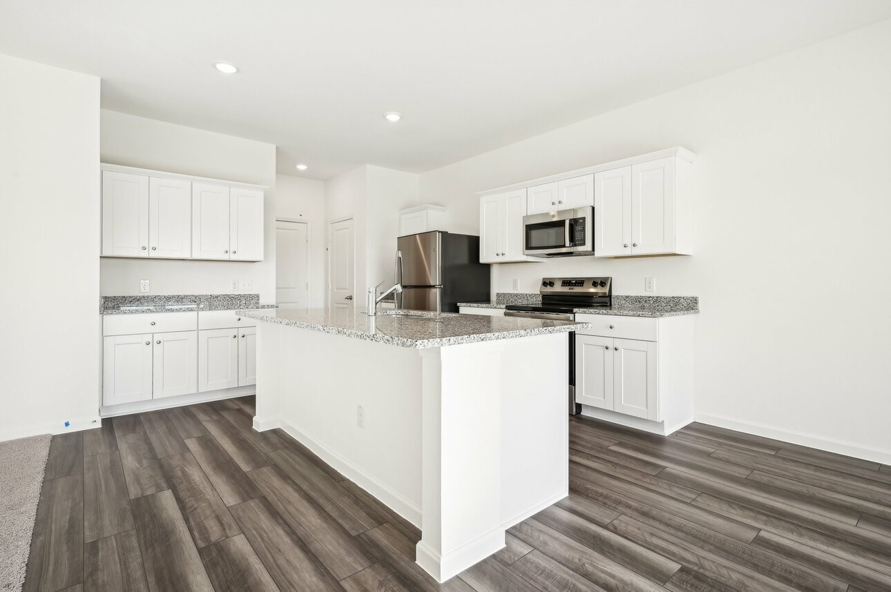 9461 Beryl Lane Conroe, TX 77303 - Photo 2 of 9 a kitchen with white cabinets and appliances