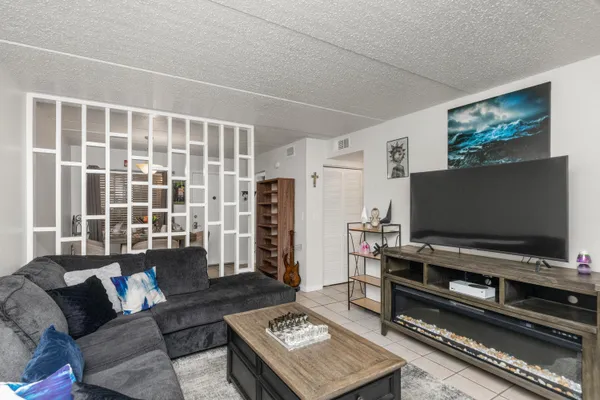 a living room with furniture and a flat screen tv