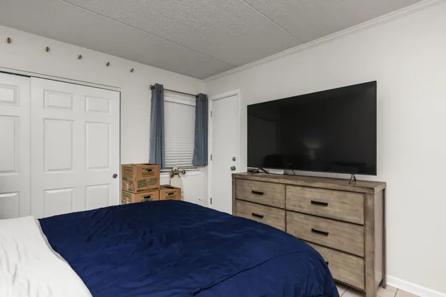 a bedroom with a bed and a flat screen tv
