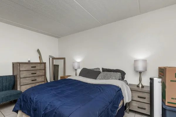 a bedroom with a bed and dresser