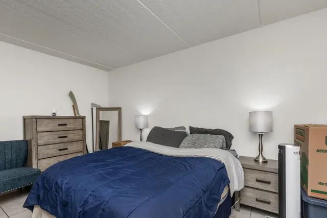 a bedroom with a bed and dresser