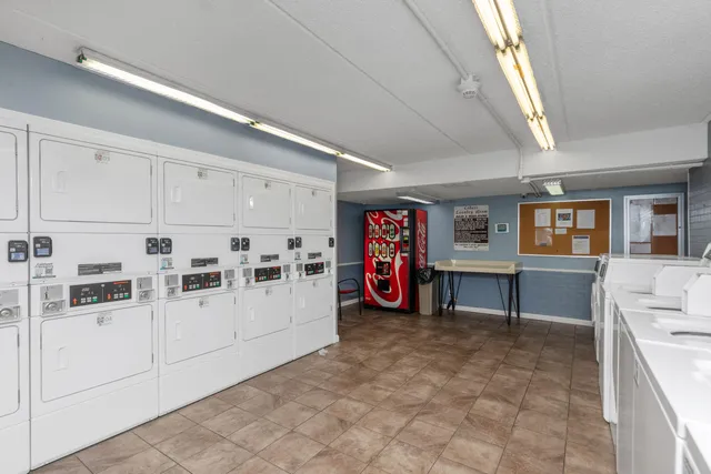 a utility room with multiple dryer and washer