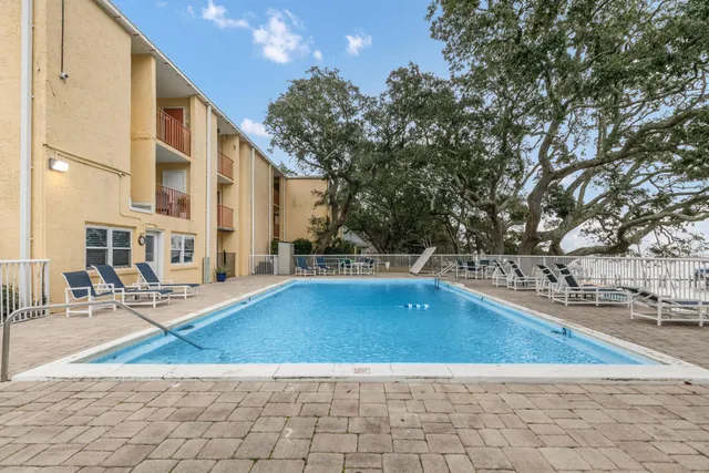 a view of a swimming pool with outdoor seating