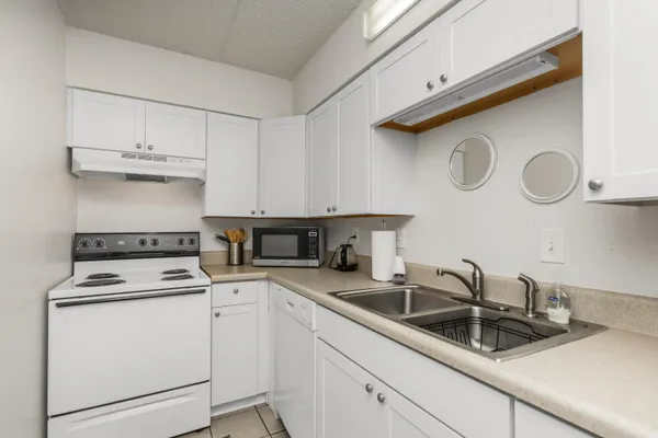 a kitchen with cabinets appliances and a sink
