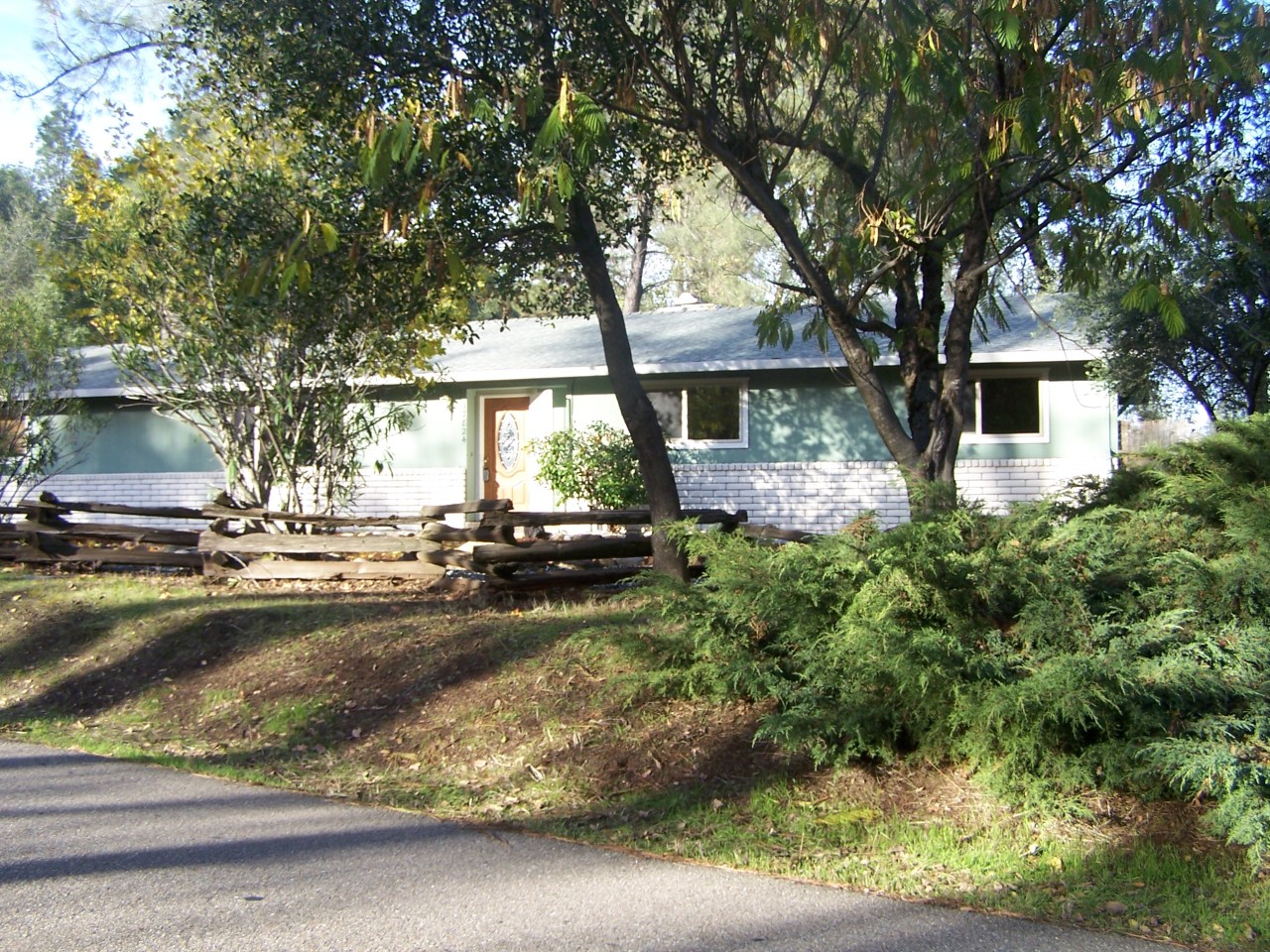 a view of a house with a yard garage and sitting area