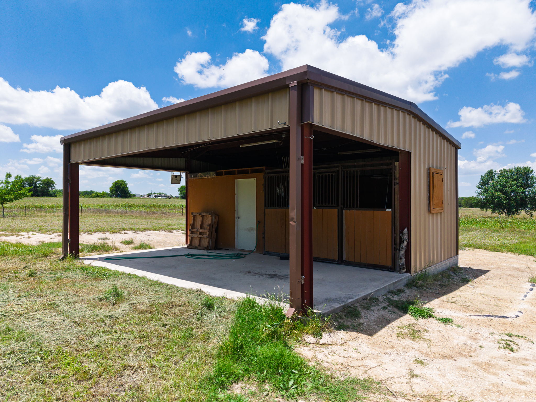 120 Rae Lane Jarrell, TX 76537 - Photo 13 of 40 Metal-sided barn structure featuring an attached covered concrete pad