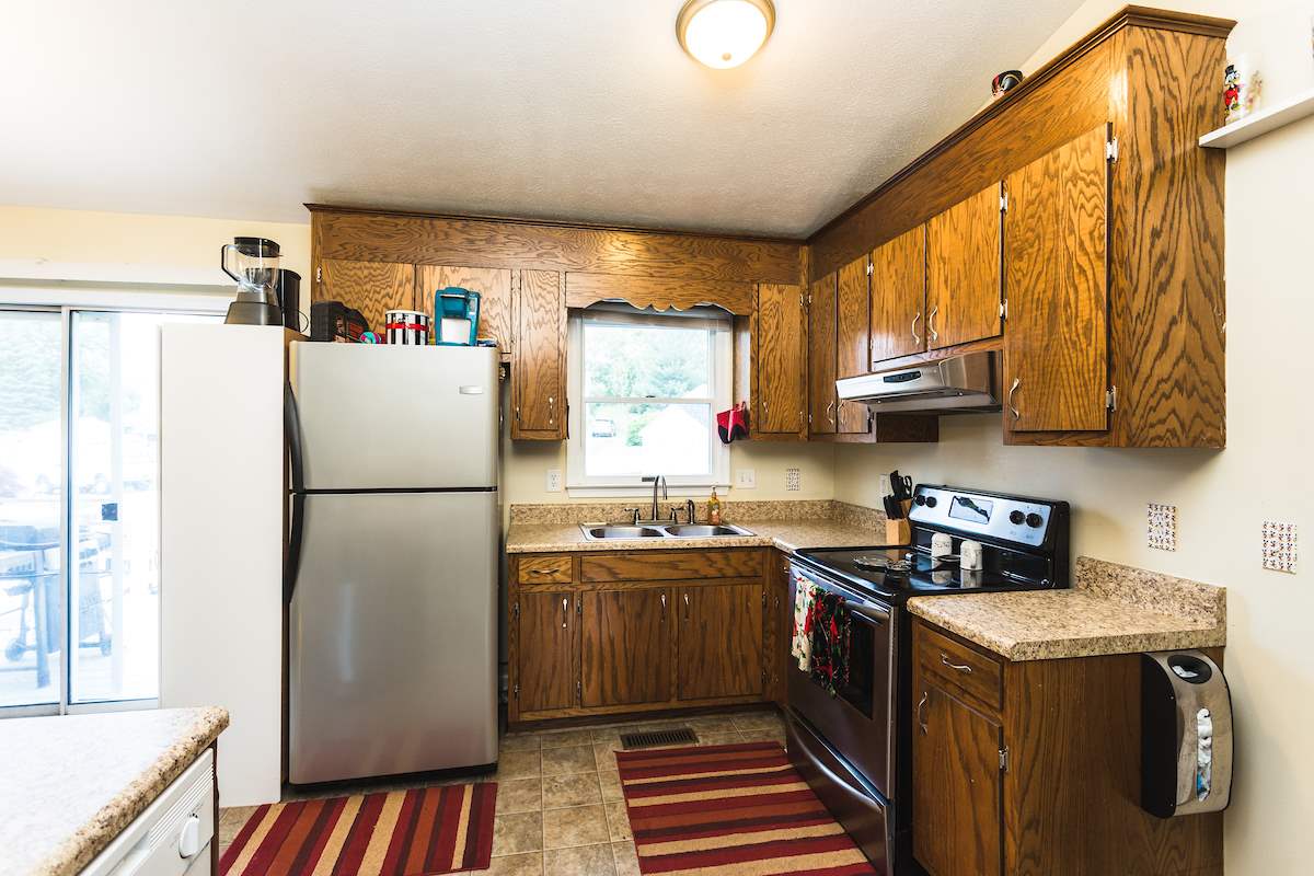 33 Ox Road Waynesboro, VA 22980 - Photo 2 of 17 a kitchen with stainless steel appliances granite countertop a refrigerator a sink dishwasher a stove with wooden cabinets and floor