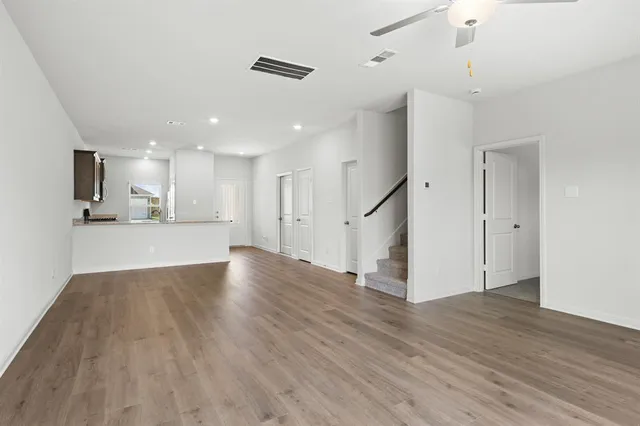 a view of a kitchen with wooden floor and a window