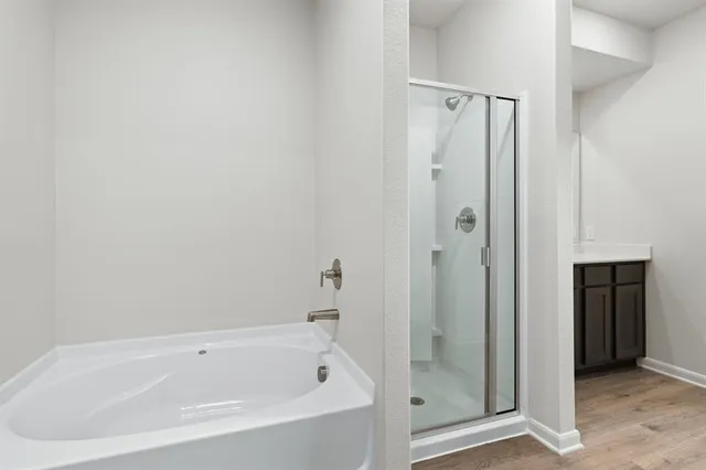 a white bath tub sitting next to a shower