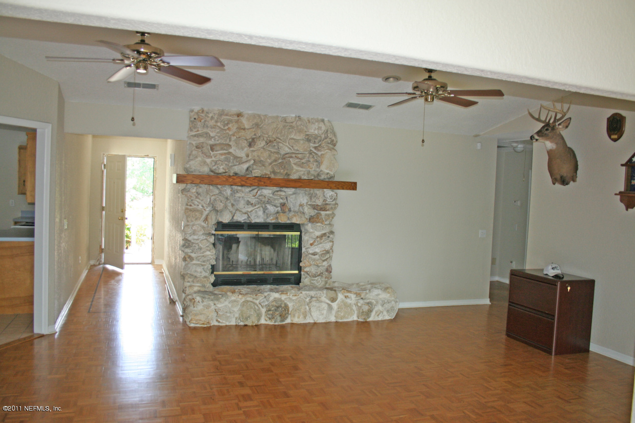 1980 Cornell Road Middleburg, FL 32068 - Photo 11 of 12 a living room with furniture and a fireplace