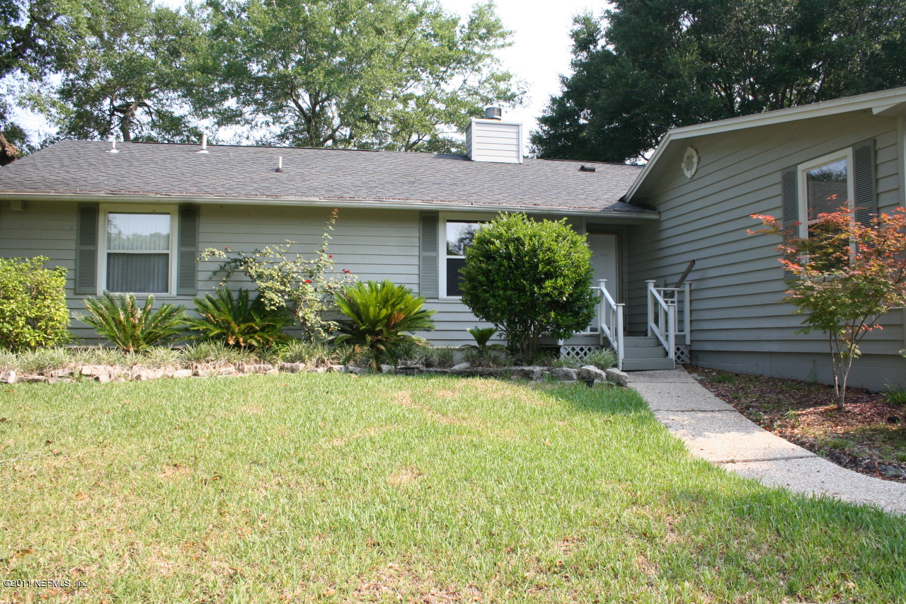 1980 Cornell Road Middleburg, FL 32068 - Photo 3 of 12 a view of a house with a yard plants and a table and chairs