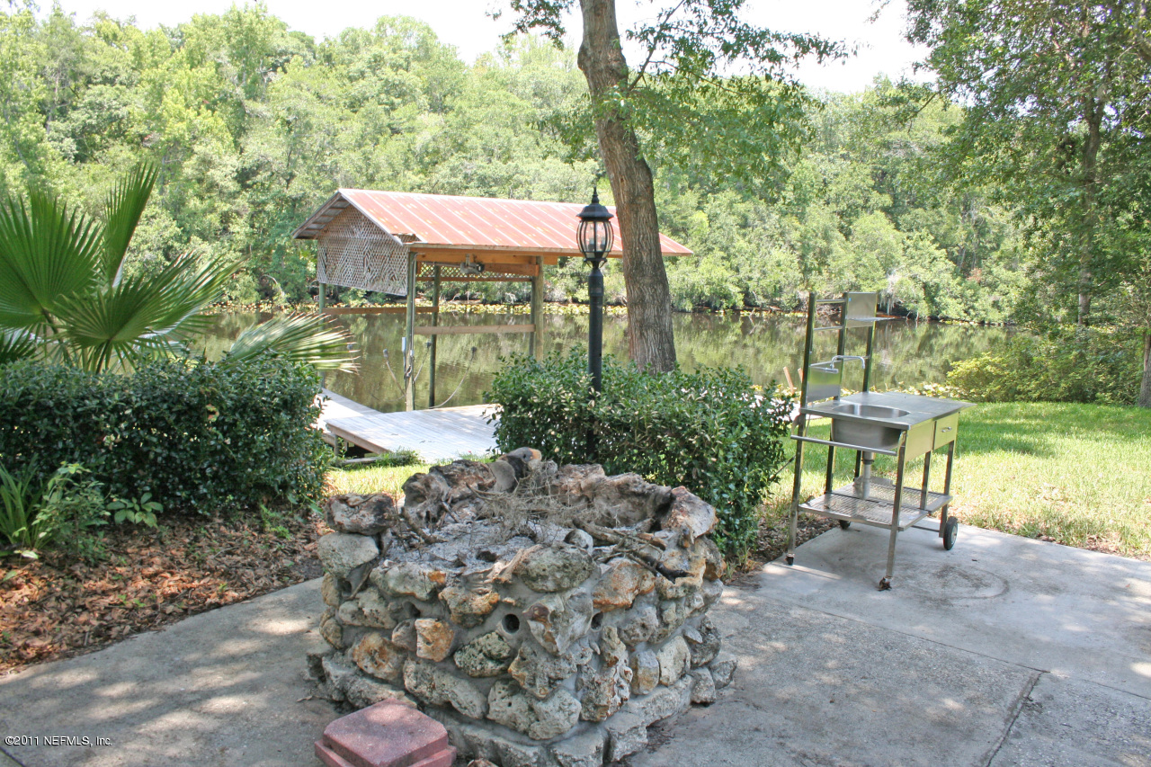 1980 Cornell Road Middleburg, FL 32068 - Photo 8 of 12 a backyard of a house with table and chairs