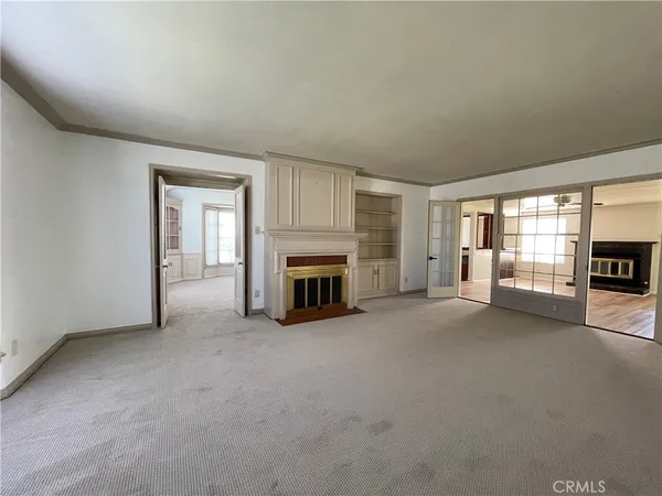 an empty room with furniture and a fireplace