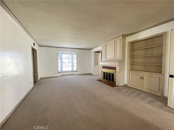 a view of a livingroom with an empty space and a fireplace