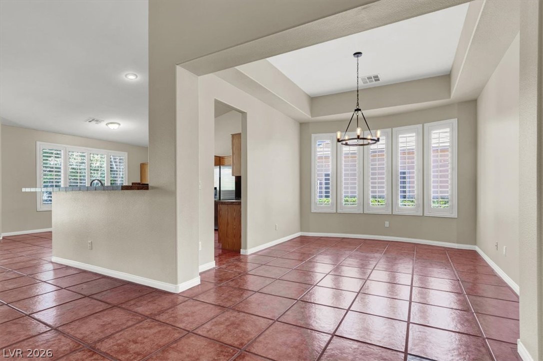 7308 Rustic Meadow Street Las Vegas, NV 89131 - Photo 3 of 27 A striking contrast of rich terra cotta tile flooring meets crisp, naturally illuminated dining space.